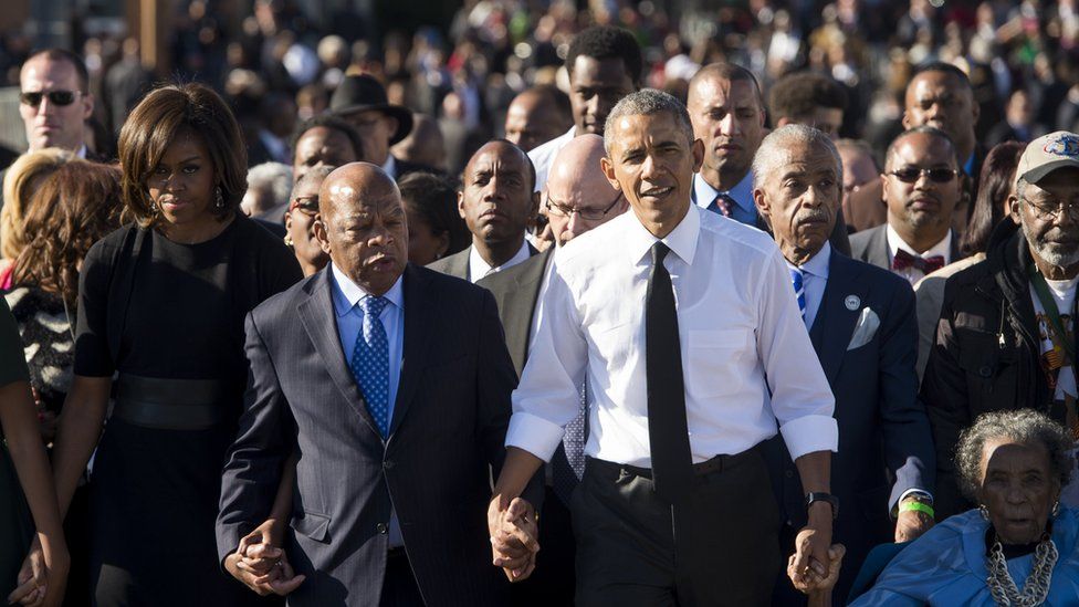 John Lewis hand in hand with Barack and Michelle Obama on the 50th Anniversary of the Selma to Montgomery civil rights march in 2015