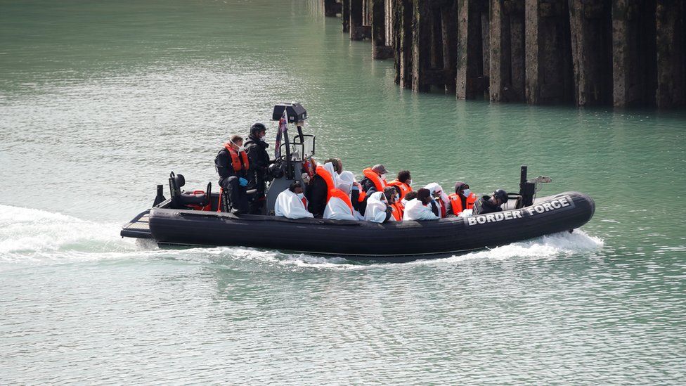 Border Patrol agents bring migrants into Dover harbour on a boat, after they tried to cross the channel, in Dover, Britain, September