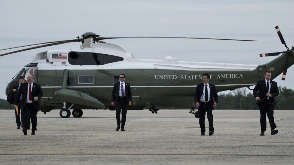 Members of the Secret Service arrive to board Air Force One to escort US President Donald Trump at Andrews Air Force Base in Maryland.
