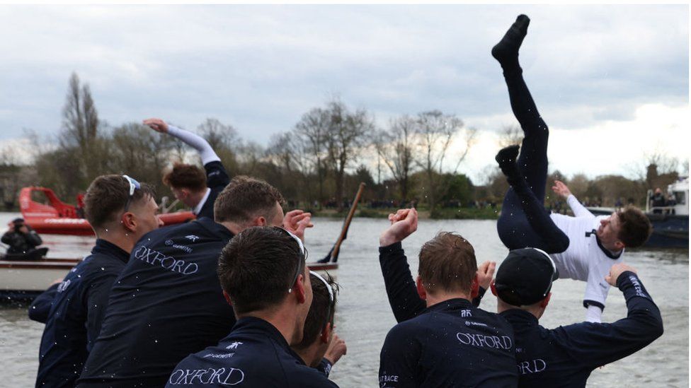 Crew throwing cox in Thames