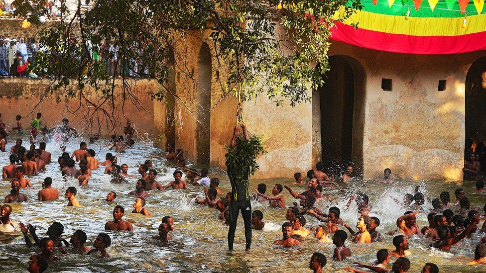 Ethiopian Orthodox Christians bathe in the Fasilides baths during the Timkat festival in Gondar on 19 January 2014.