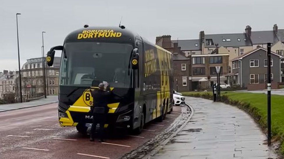 The Borussia Dortmund bus being issued with a parking ticket in Tynemouth