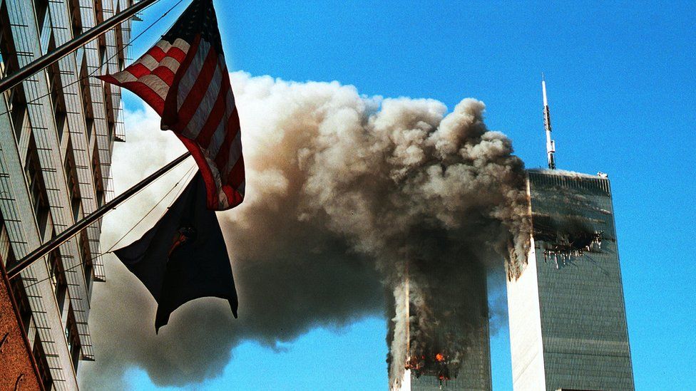 Smoke pours from the World Trade Center towers after they were hit by two planes on September 11, 2001