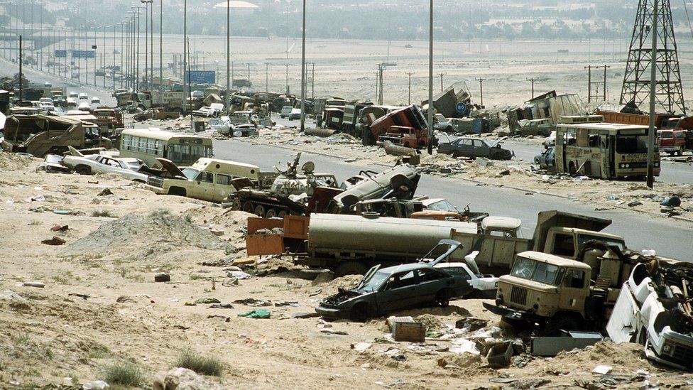 Demolished vehicles line Highway 80, also known as the "Highway of Death", the route fleeing Iraqi forces took as they retreated from Kuwait during Operation Desert Storm.