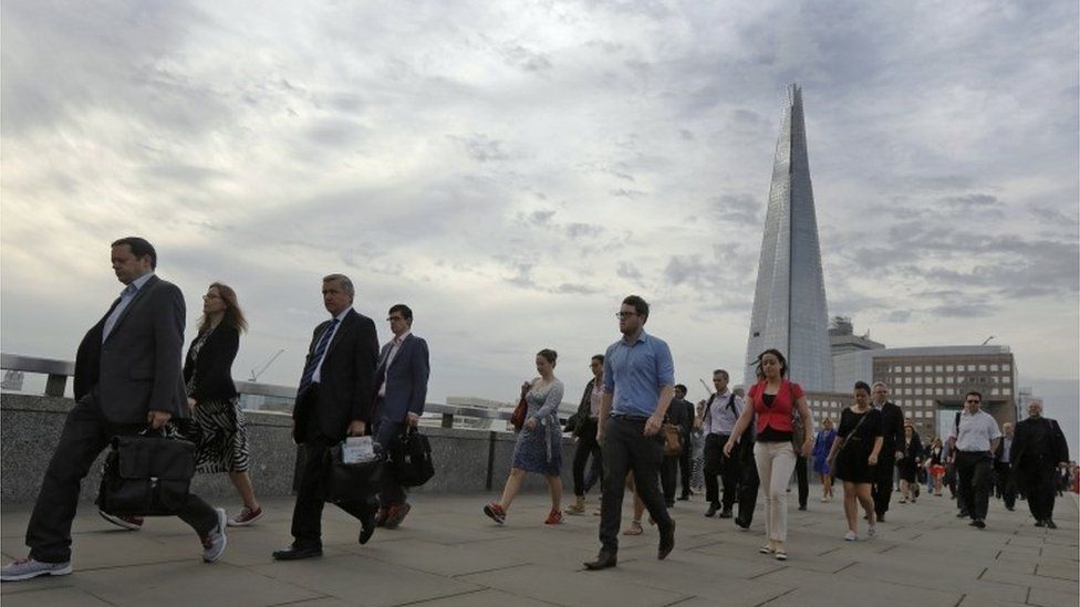 Workers walking across London Bridge
