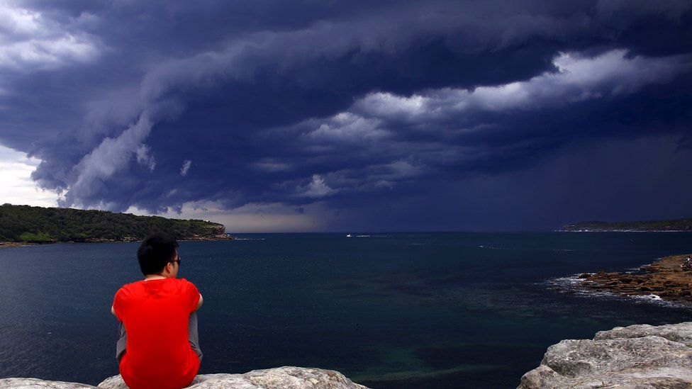 Man watching storm clouds