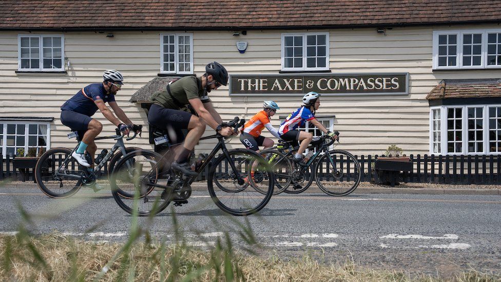 Cyclists at the Axe & Compasses in Aythorpe Roding
