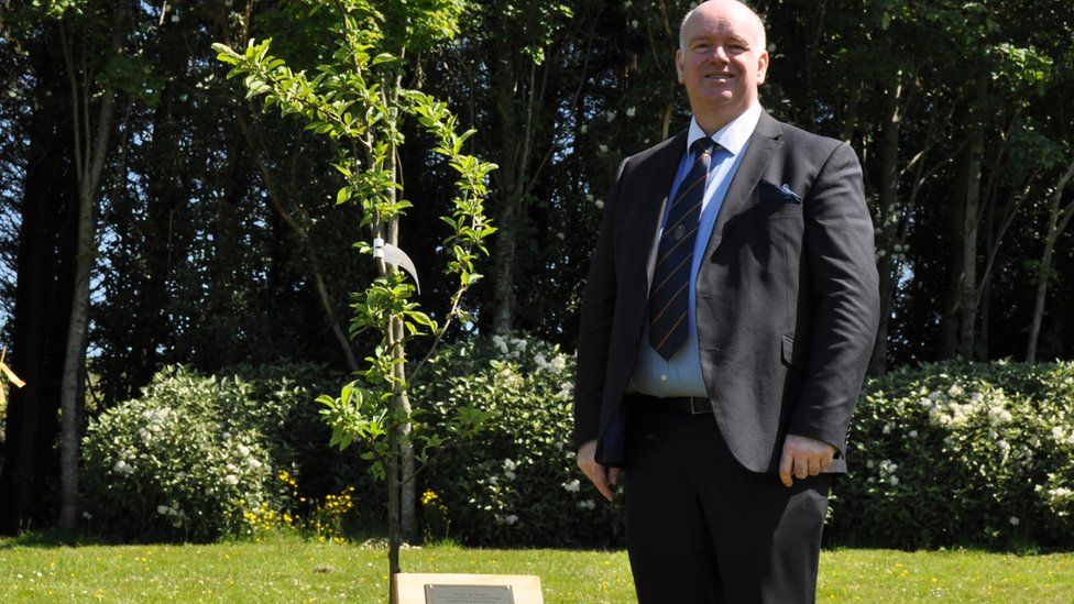 Chief Minister Howard Quayle standing next to a tree