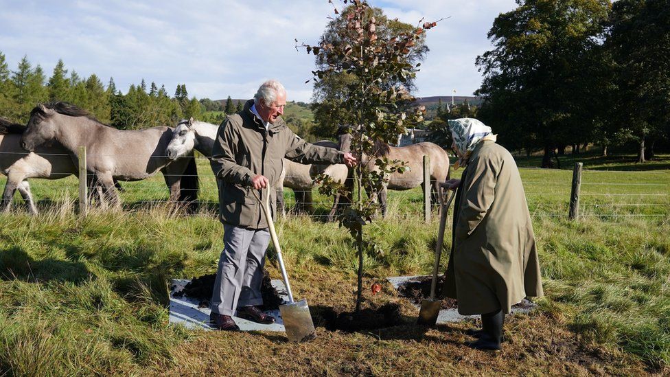 Queen Elizabeth and Prince Charles planting a tree