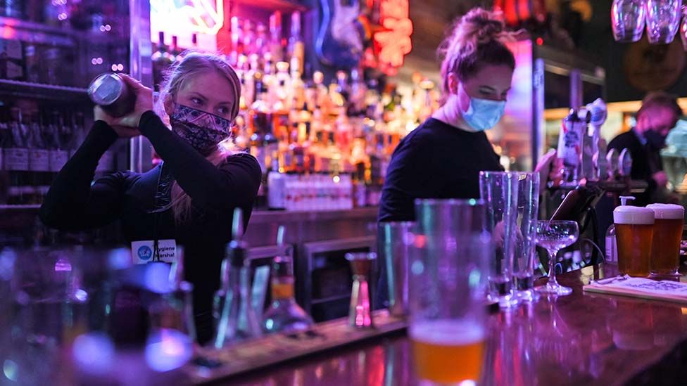 Bar worker mixes cocktails