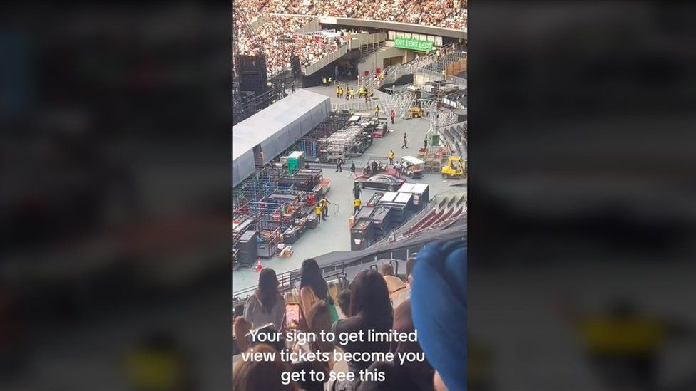 Liliana's backstage view from her restricted view seats. You can see the back of the stage with fans on the other side, exits and dozens of crates as well as The Weeknd's car and other vehicles. This is a still from a video Liliana shared on TikTok which she has captioned: 'Your sign to get limited view tickets become [sic] you get to see this'
