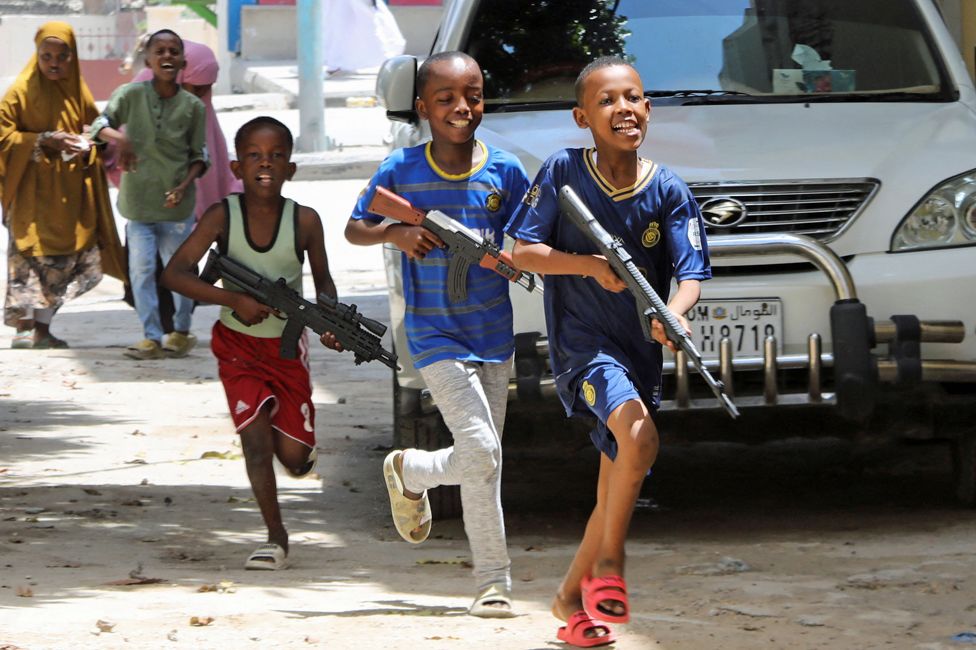 Boys with toy guns running in Mogadishu, Somalia - Wednesday 10 April 2024