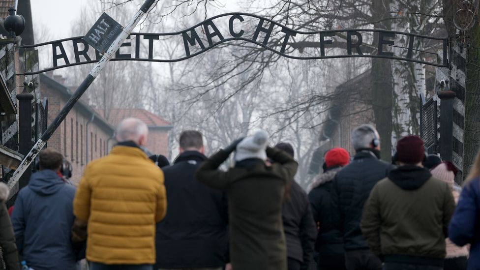 File photo of visitors walking under the "Work Makes One Free" ("Arbeit Macht Frei") inscription at the entrance to the Auschwitz I memorial concentration camp site on 15 February 2019 in Oswiecim, Poland