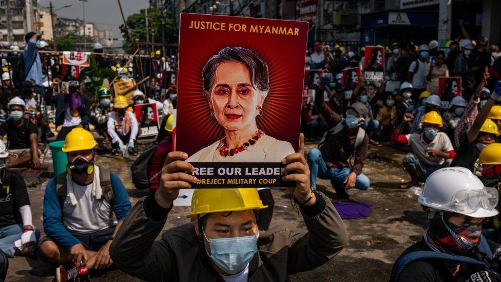 An anti-coup protester holds up a placard featuring de-facto leader Aung San Suu Kyi on March 02, 2021 in Yangon, Myanmar