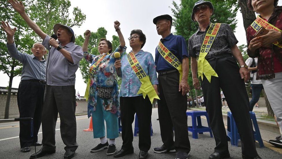 Family members of South Korean victims of forced labour by Japan during World War Two, participate in a rally urging resolution of compensation in Seoul on 16 July