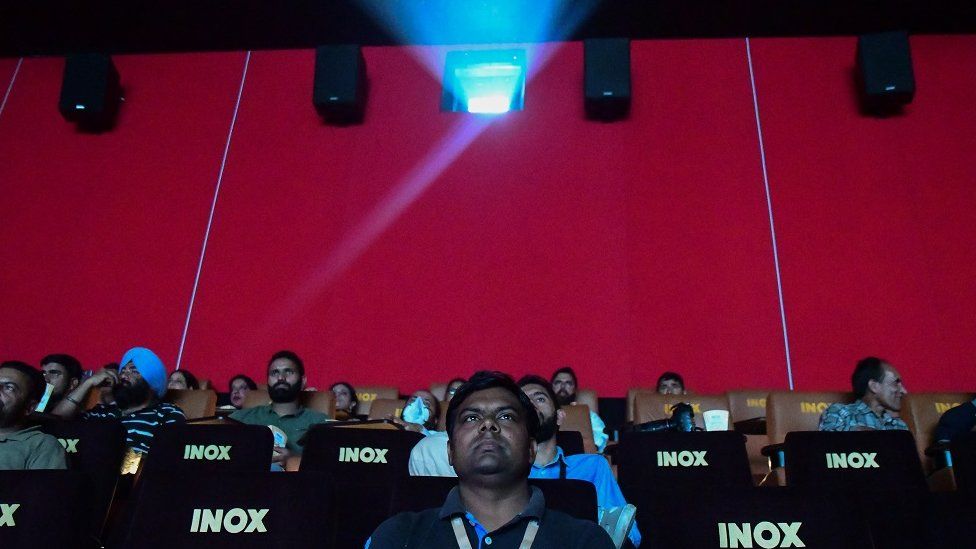 People watch a film inside the new theatre