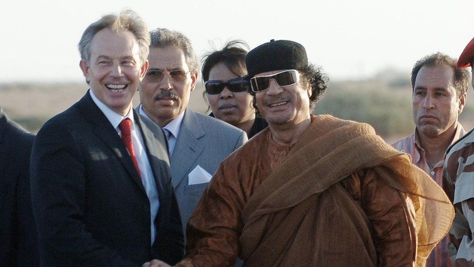 File photo of Tony Blair and Muammar Gaddafi shaking hands Gaddafi"s desert base near Sirte, Libya