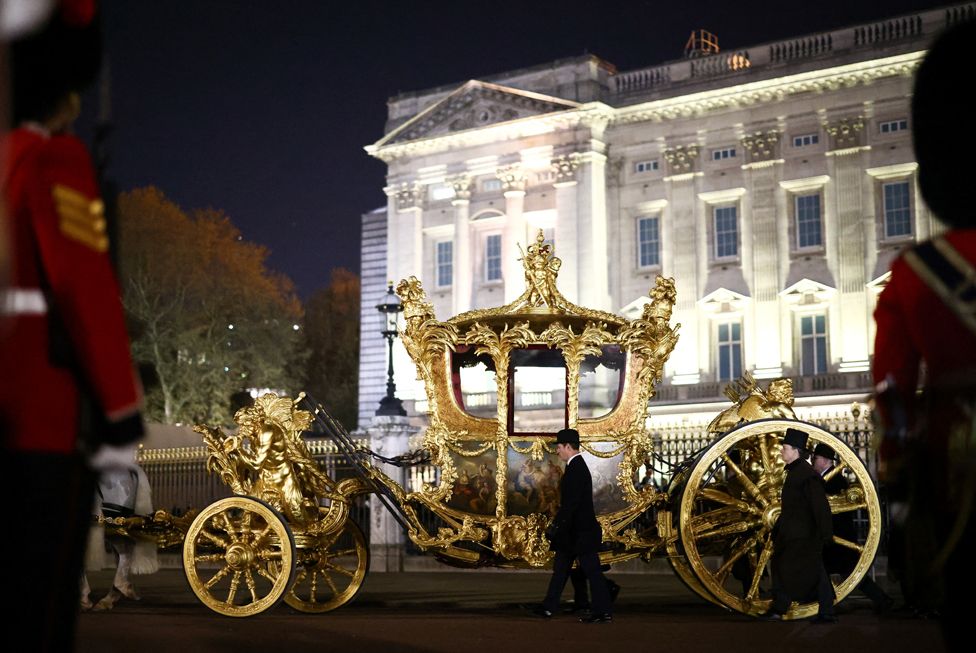 The Gold State Coach is ridden alongside members of the military during a full overnight dress rehearsal of the Coronation Ceremony.