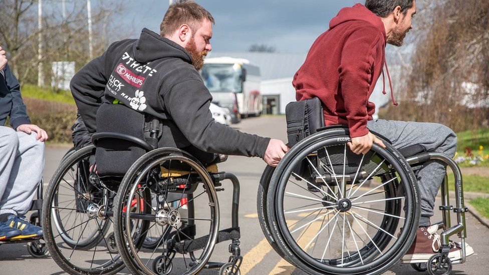 Wheelchair users practising on kerbs