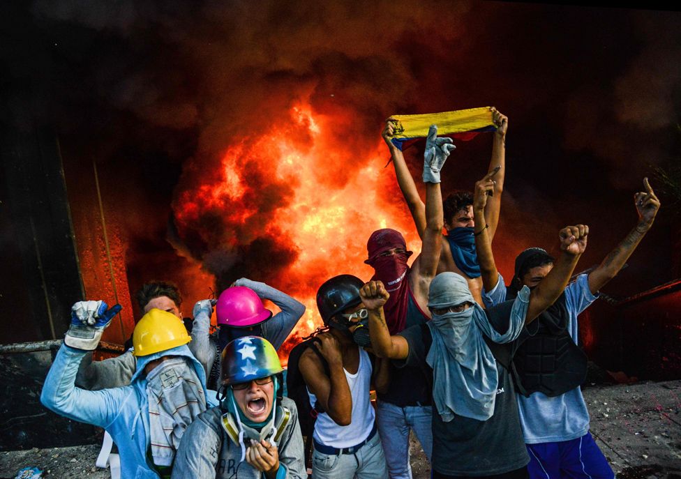 Anti-government demonstrators participate in an attack to the administration headquarters of the Supreme Court of Justice as part of protests against President Nicolas Maduro in Caracas, on June 12, 2017.