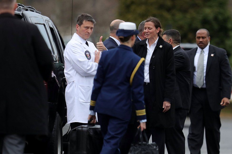 Dr Ronny Jackson gives a thumbs-up after outside Walter Reed National Military Medical Center in Bethesda, Maryland, 12 January 2018