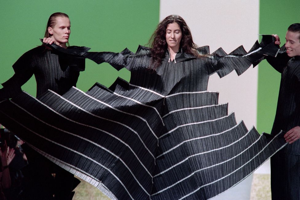 Models display a Pleats Please dress as part of Issey Miyake's Ready-to-Wear Autumn-Winter 1995 fashion show in Paris, France