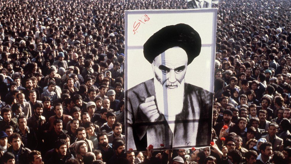Iranian protestors hold a up a poster of Ayatollah Khomeini during a demonstration in Tehran (January 1979)