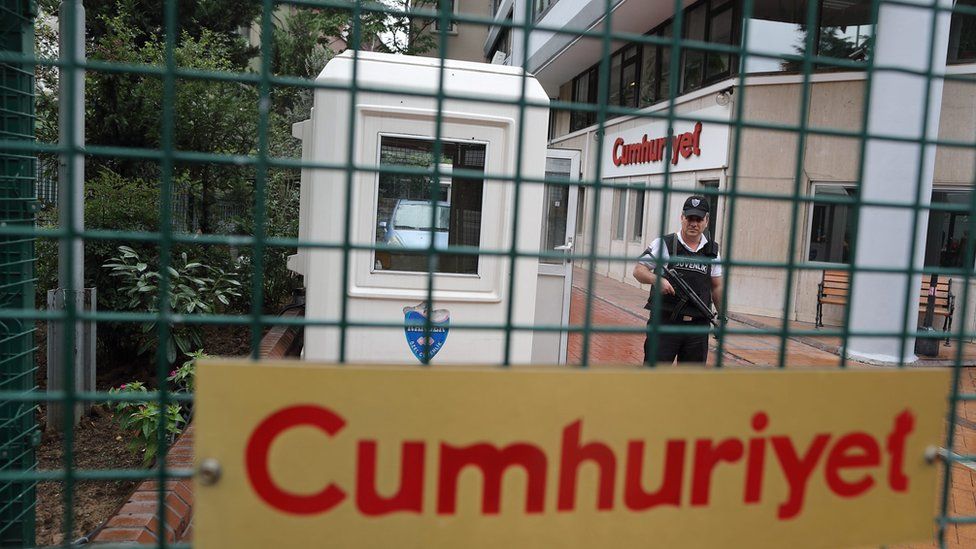 An armed private security officer on guard in front headquarter of Cumhuriyet daily newspaper in Istanbul, Turkey on 22 September