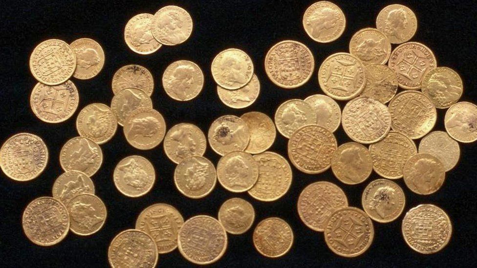 Gold coins on black background