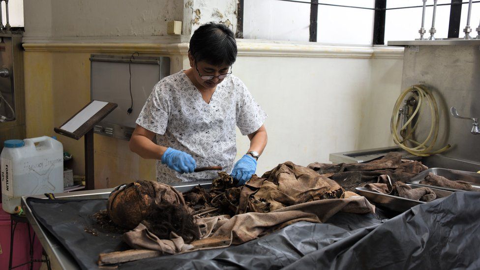 Forensic pathologist Raquel Fortun examines bones of Duterte drug war victims in Manila