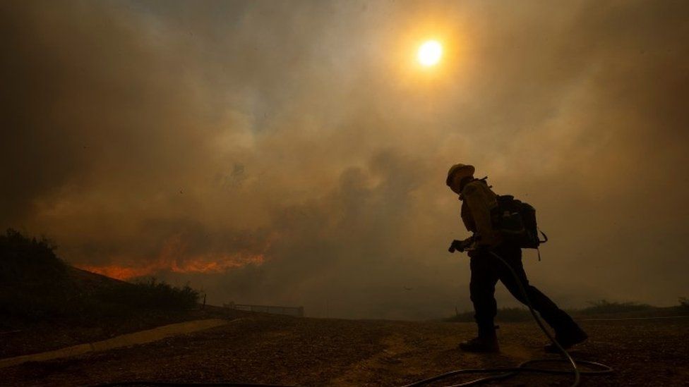Firefighters are seen as the Silverado Fire approaches, near Irvine, California