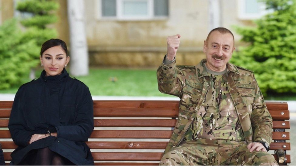 Azerbaijan President Ilham Aliyev (R) and first lady Mehriban Aliyeva (L) meeting with servicemen undergoing treatment