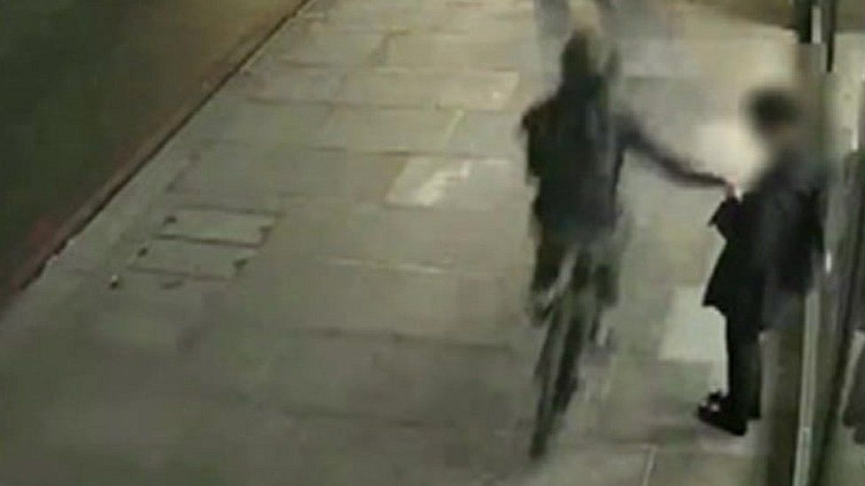 CCTV still of person on bike snatching phone