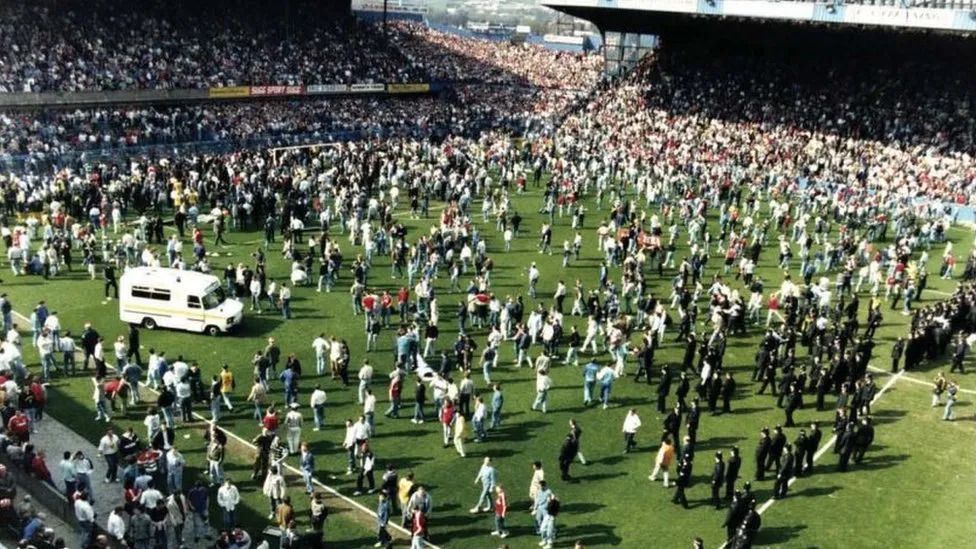 Archive picture of fans on the pitch during the Hillsborough disaster in 1989