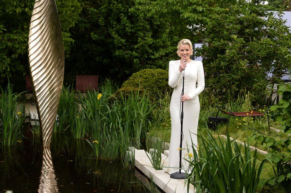 Jazz singer Natalie Rushdie as the Lady of the Lake in the Savills and David Harber Garden, designed by Andrew Duff