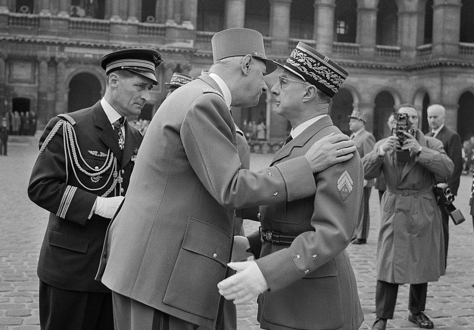 President Charles de Gaulle presents the cross of the Legion of Honor to General Charles Ailleret on March 10, 1960 during a military rally in the Cour d'honneur of the Invalides in Paris