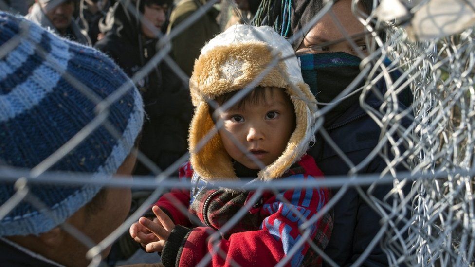 Afghan migrants behind a fence near Gevgelija, Macedonia