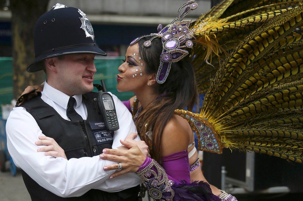 Police officer and parade reveller at the Notting Hill Carnival