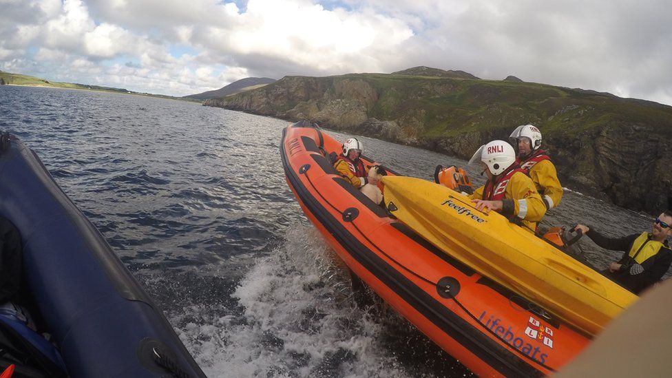 The sheep was comforted by RNLI crew after her 200ft fall