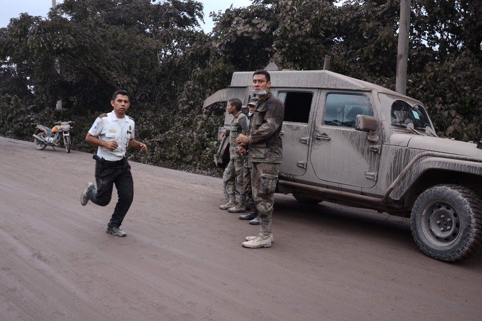 Police officers and soldiers work in El Rodeo village, Escuintla department, 3 June