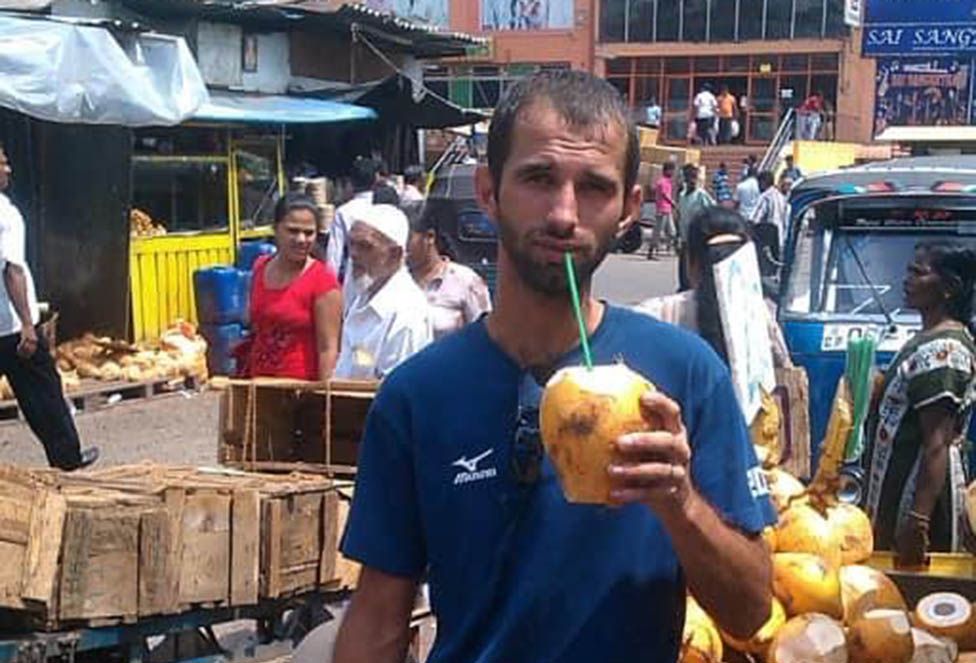 Volodymyr drinking from a coconut