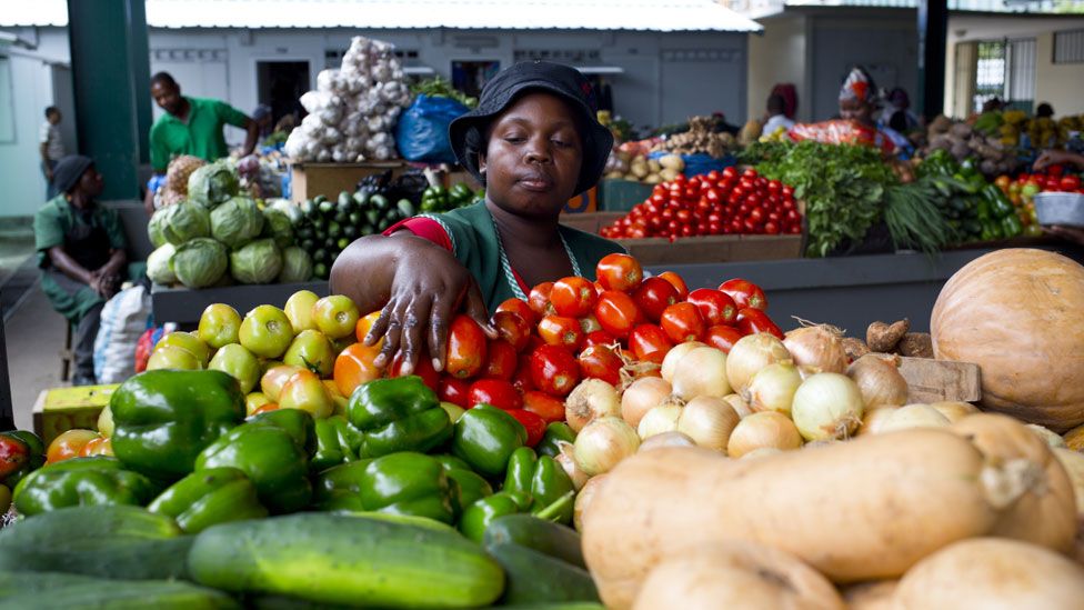 A woman handles fruit in the Maputo city market on January 11, 2014.
