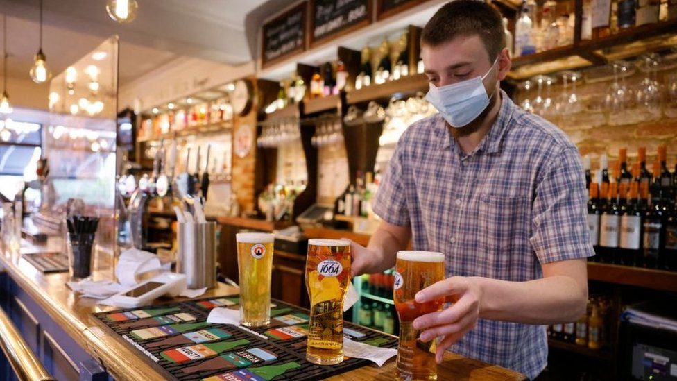 Barman serving pints