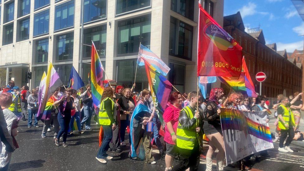 One group on parade with pride flags