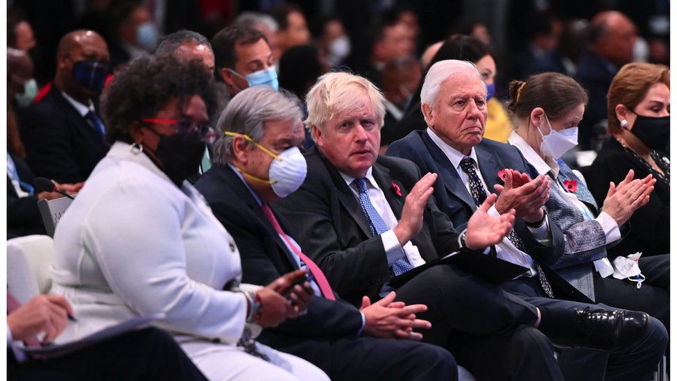 Boris Johnson sat at COP26 without a mask, next to Sir David Attenborough also not wearing a mask.