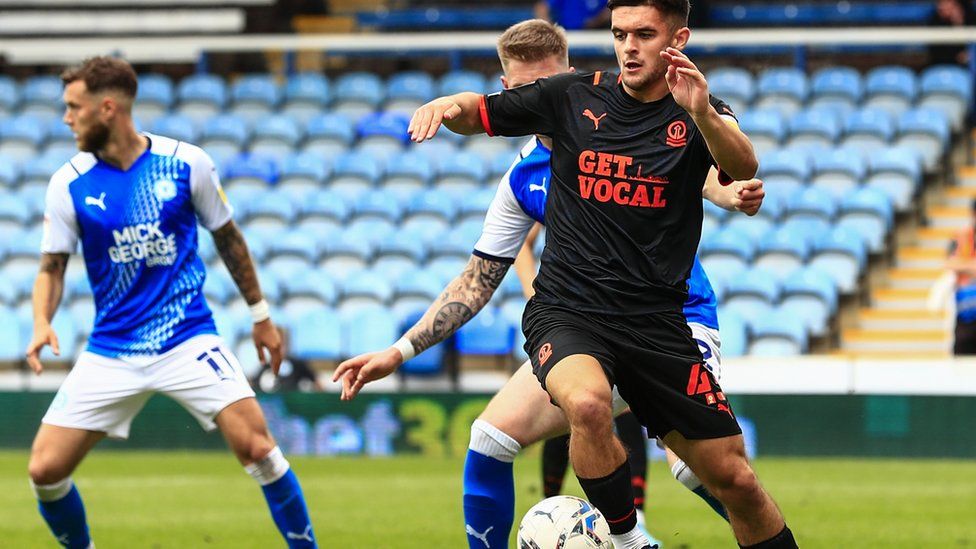 Jake Daniels playing in a match between Peterborough United and Blackpool