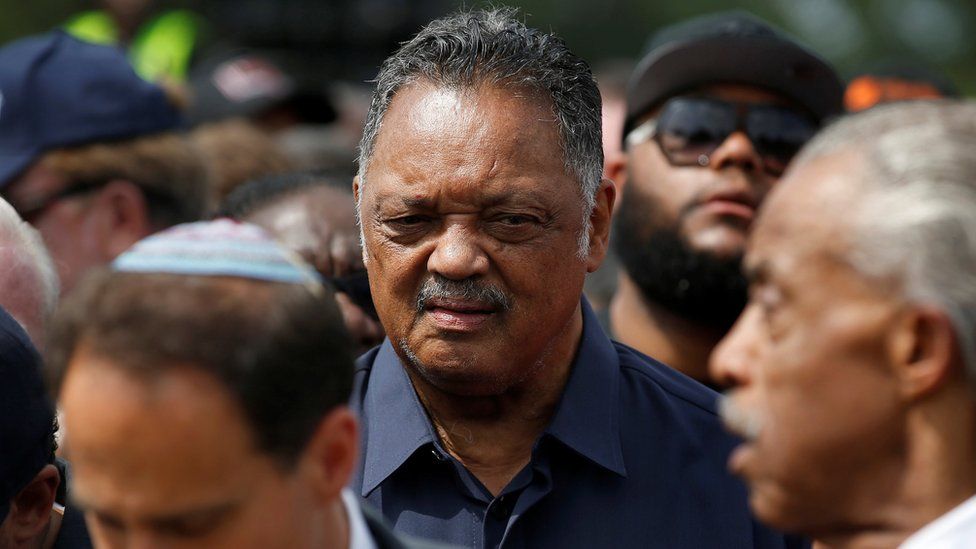 Reverend Jesse Jackson with fellow activist Reverend Al Sharpton (R) at the start of a march to the Department of Justice, August 28, 2017.