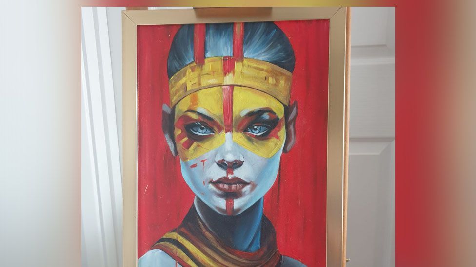 Painting of a woman. She has yellow paint around her eyes and a blue face.
The canvas behind her has been painted red