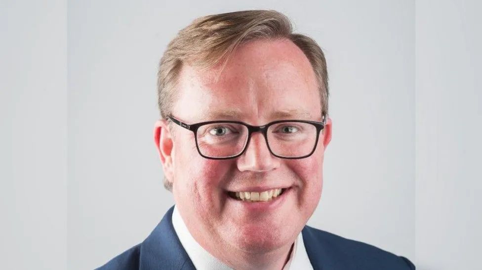 Headshot of Conservative Councillor Mark Hawthorne in a blue suit and white shirt 