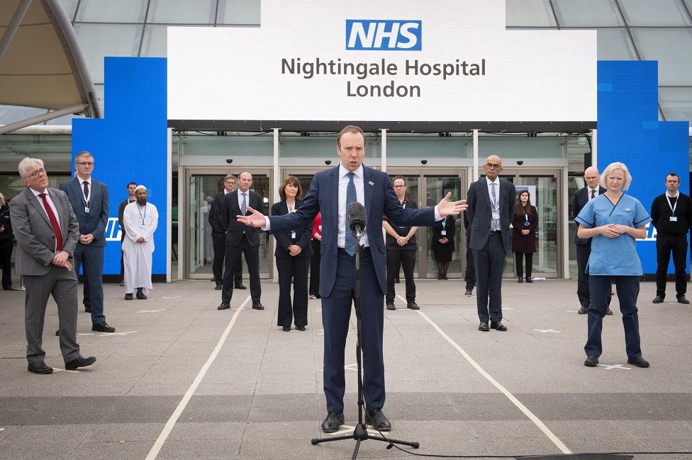 Matt Hancock stands in front of NHS Nightingale Hospital
